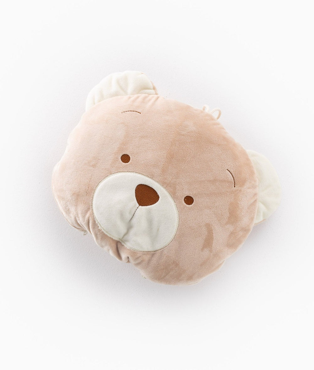 Compact tan bear face travel pillow in closed form with cream ears