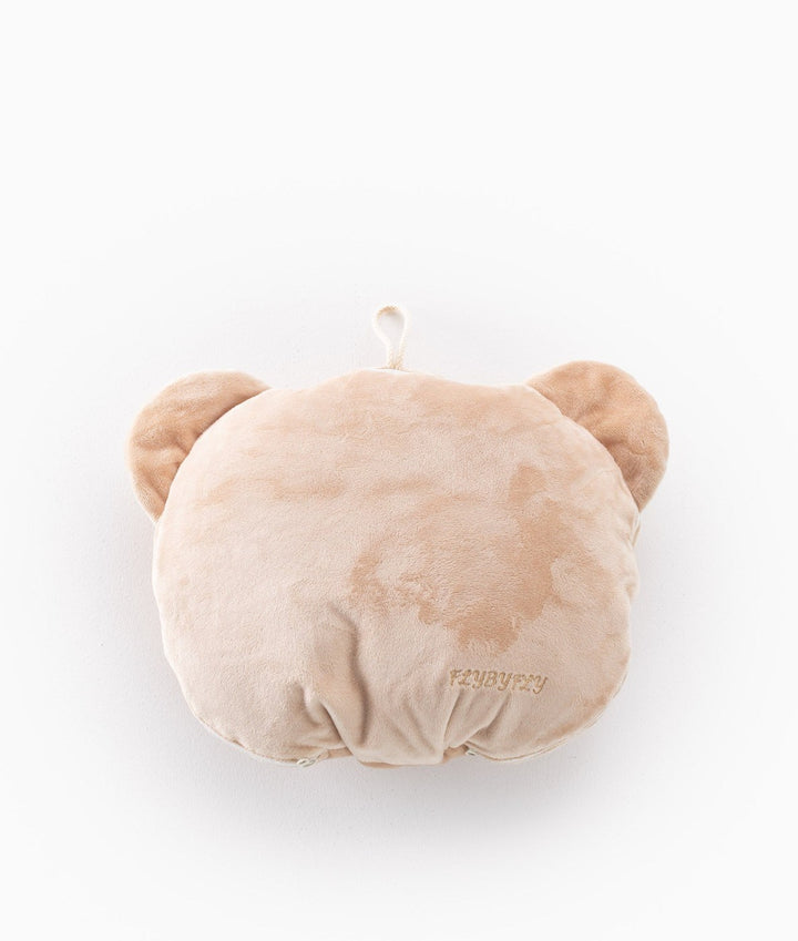 Back view of folded tan bear travel pillow with hanging loop and logo