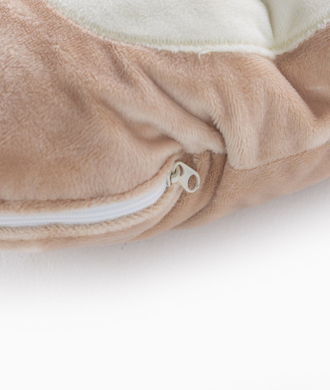 Macro detail of soft beige plush fabric texture and white zipper track