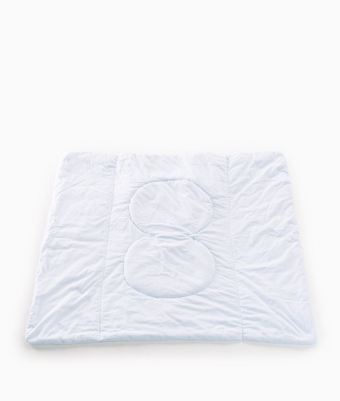 Reverse side of light blue quilted travel blanket with padded pillow zones