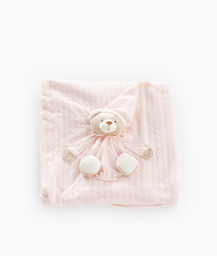Light pink cotton baby blanket with honeycomb texture and teddy bear detail