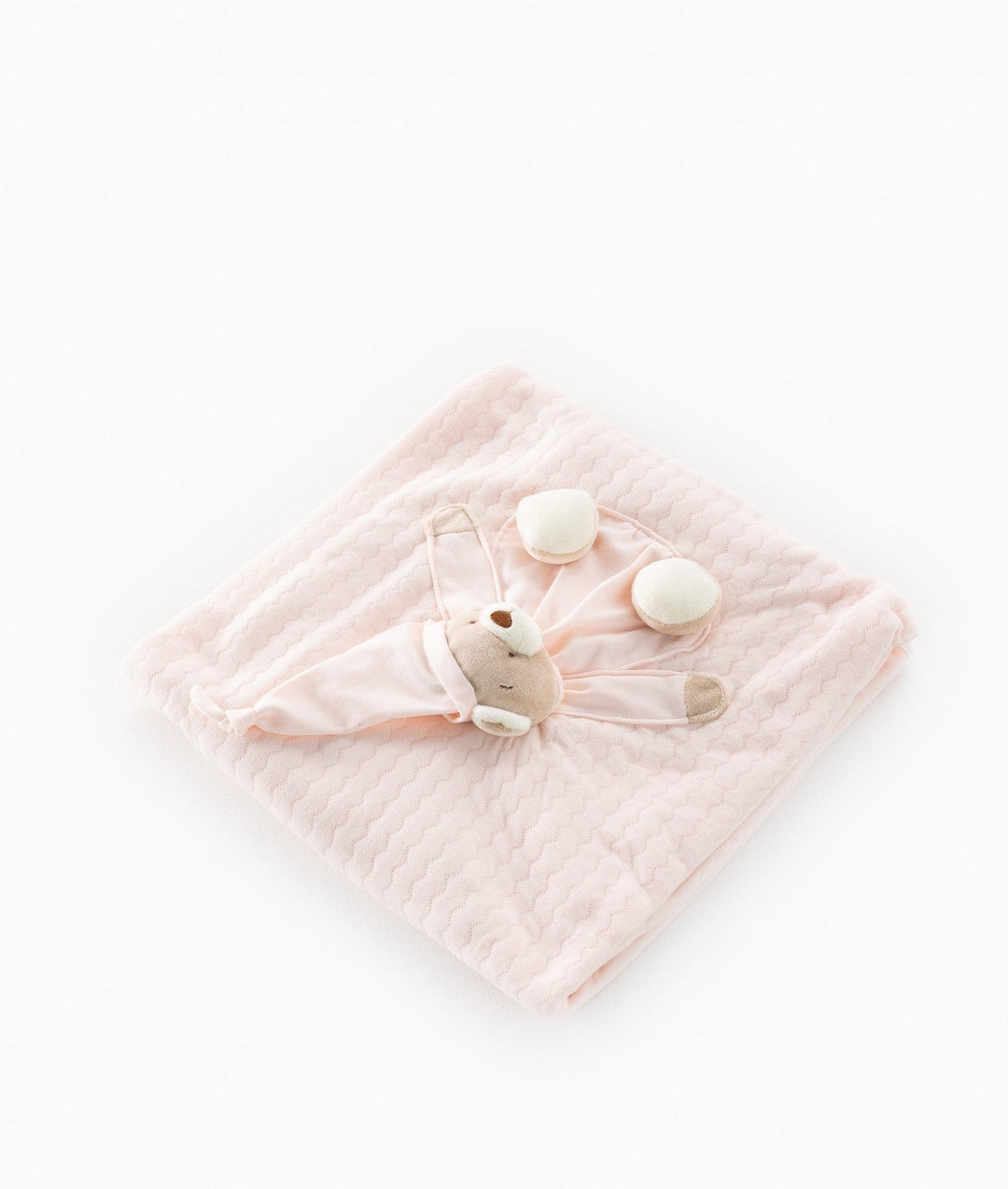 Pale pink quilted baby blanket showing soft fabric weave and 3D bear design