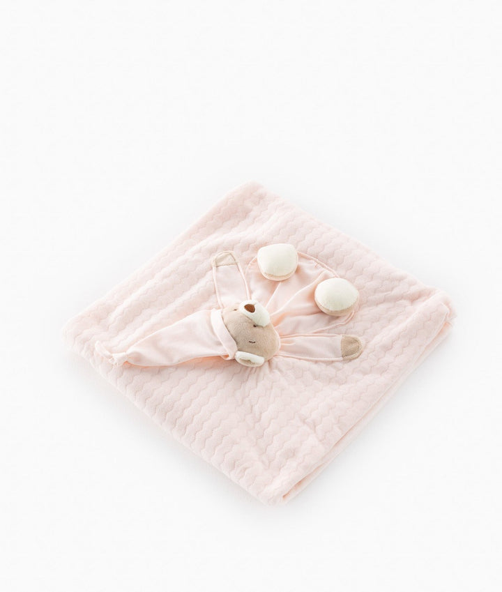 Pale pink quilted baby blanket showing soft fabric weave and 3D bear design