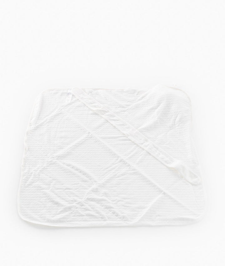 Back view of unfolded white diamond quilted cotton swaddle with velcro strip