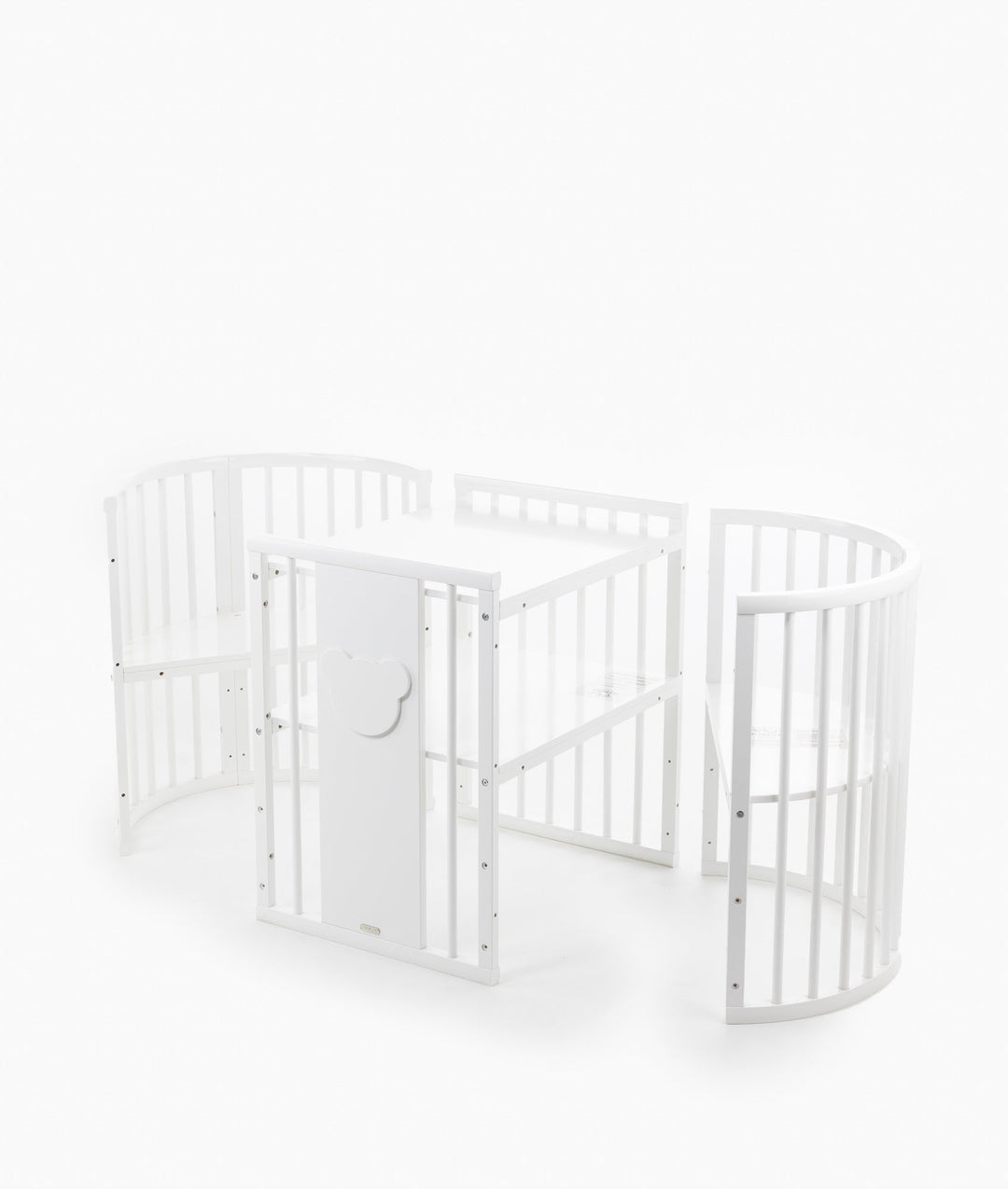 White baby cot with teddy bear design styled in a neutral nursery room