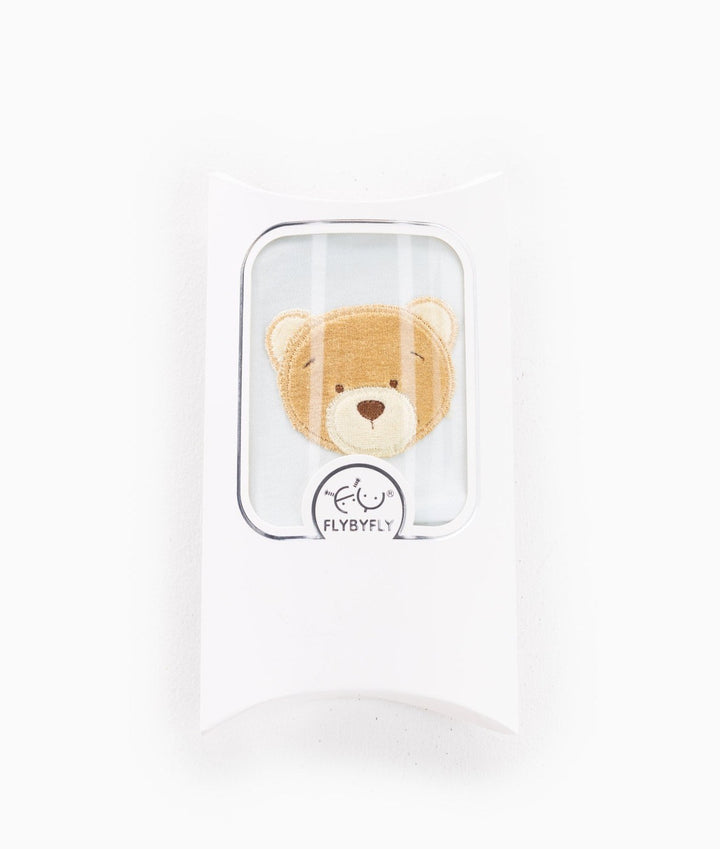 white pillow box packaging with clear window revealing blue beanie inside and FLYBYFLY logo seal