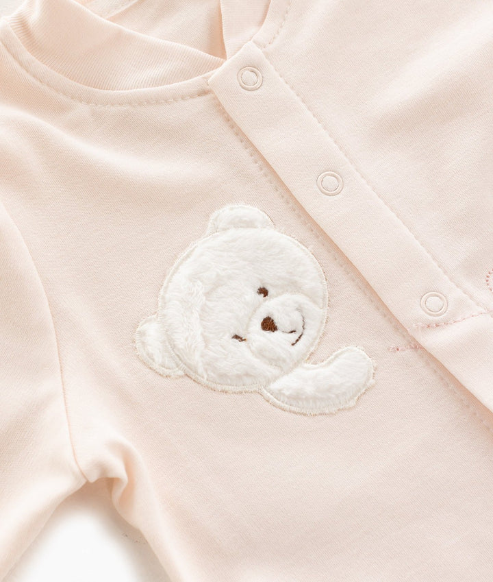 Soft pink cotton baby top with round neckline and textured white fuzzy teddy bear patch