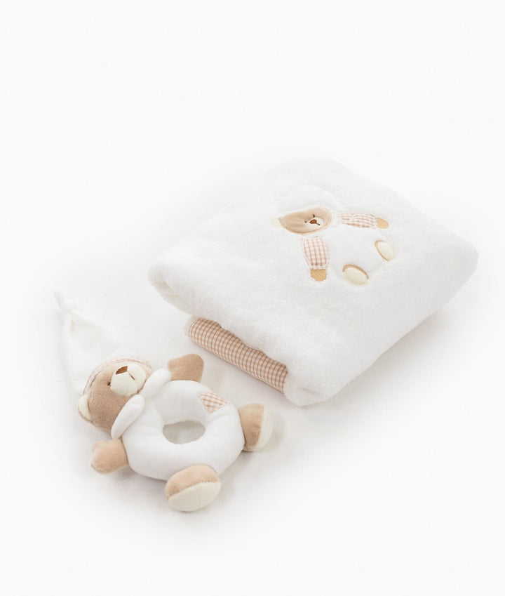 Folded white cotton towel with pink gingham bear applique and rolled hem