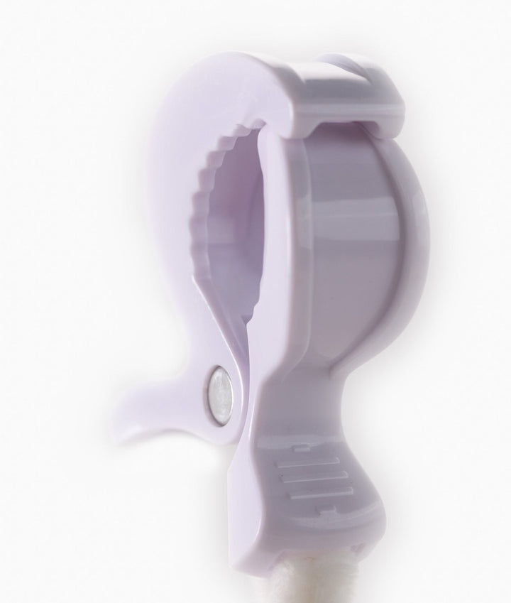 Close up of light purple serrated plastic clip mechanism for prams or car seats