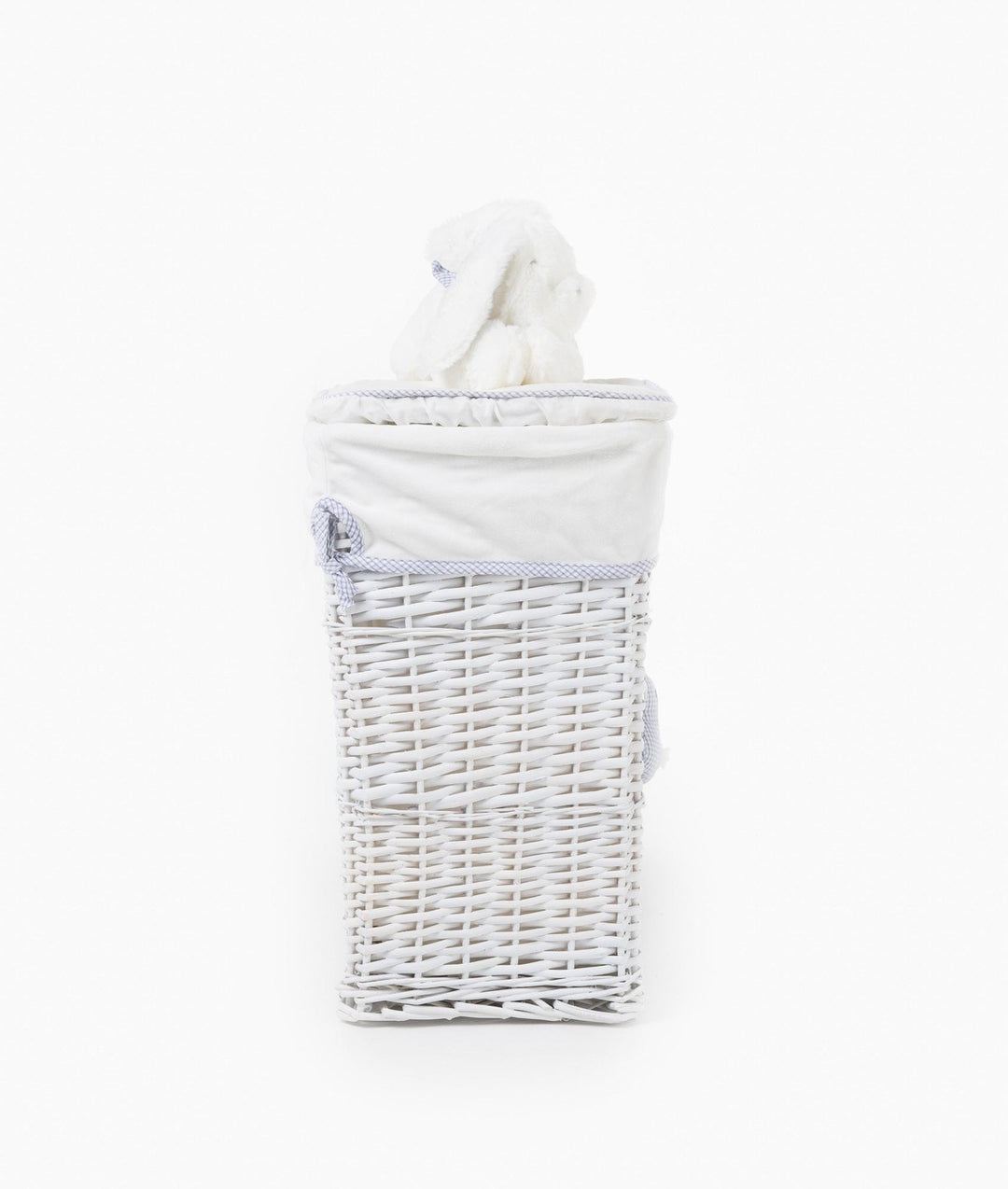 Back view of white wicker laundry basket with cream liner, blue gingham trim, and bunny toy peeking out