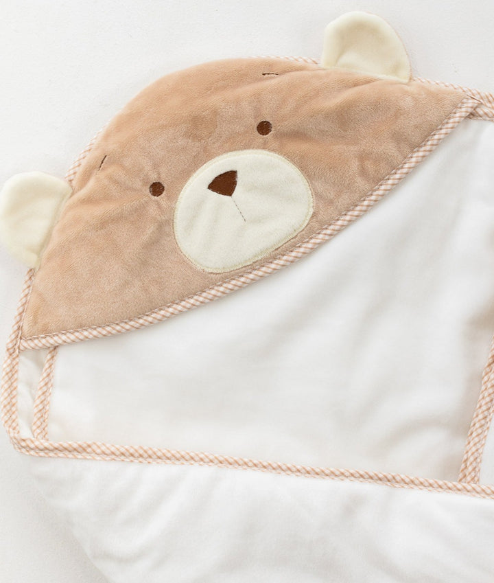 Close up of embroidered bear hood on soft white baby swaddle fabric