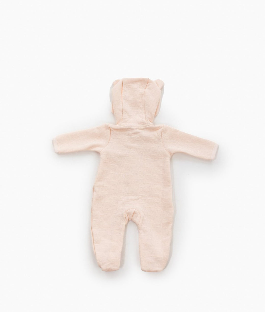Back view of light pink hooded baby jumpsuit showing smooth cotton texture