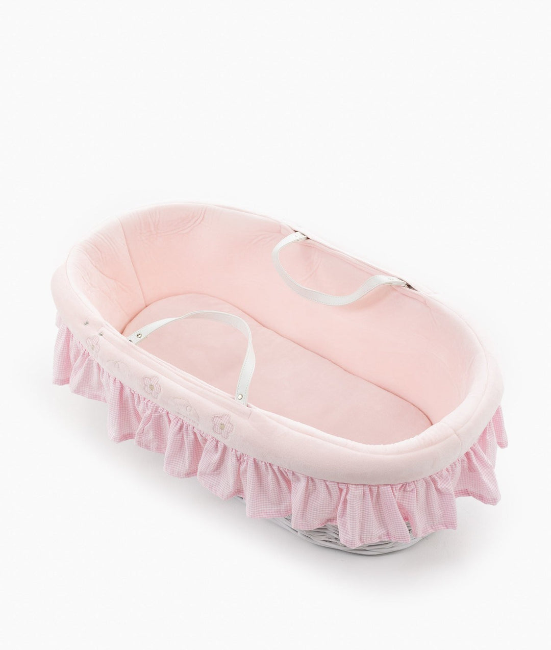 Isolated white wicker Moses basket with pink plush lining and gingham trim
