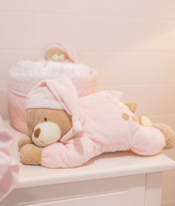 Plush tan bear in soft pink hooded sleep sack with embroidered buttons