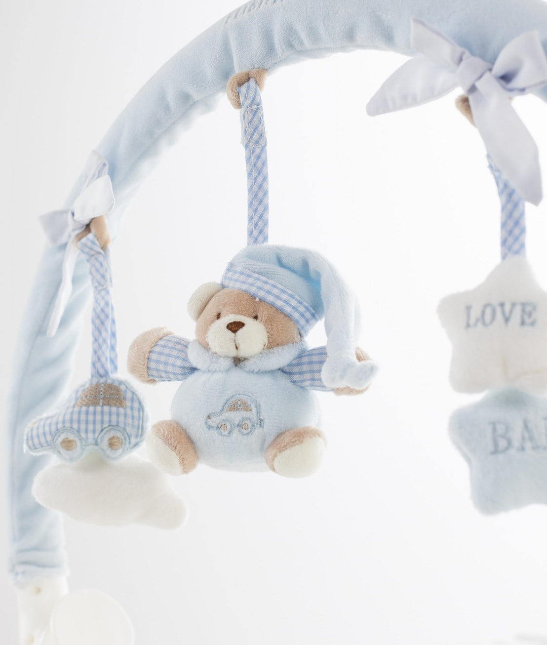 Light blue plush portable toy arch with hanging teddy bear in checkered nightcap and car pajamas