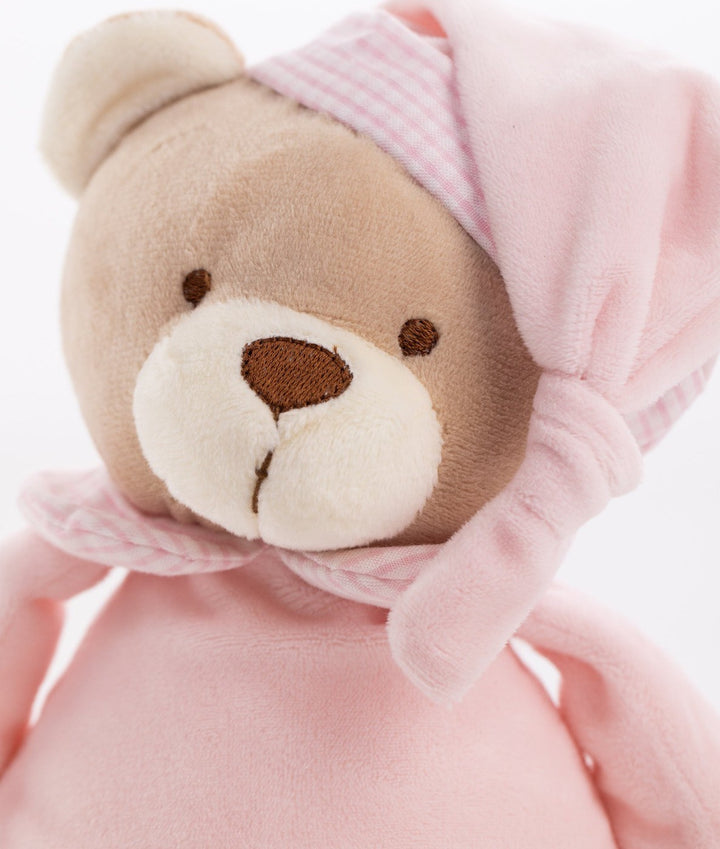 Macro shot of pink teddy bear face embroidery and hat band texture