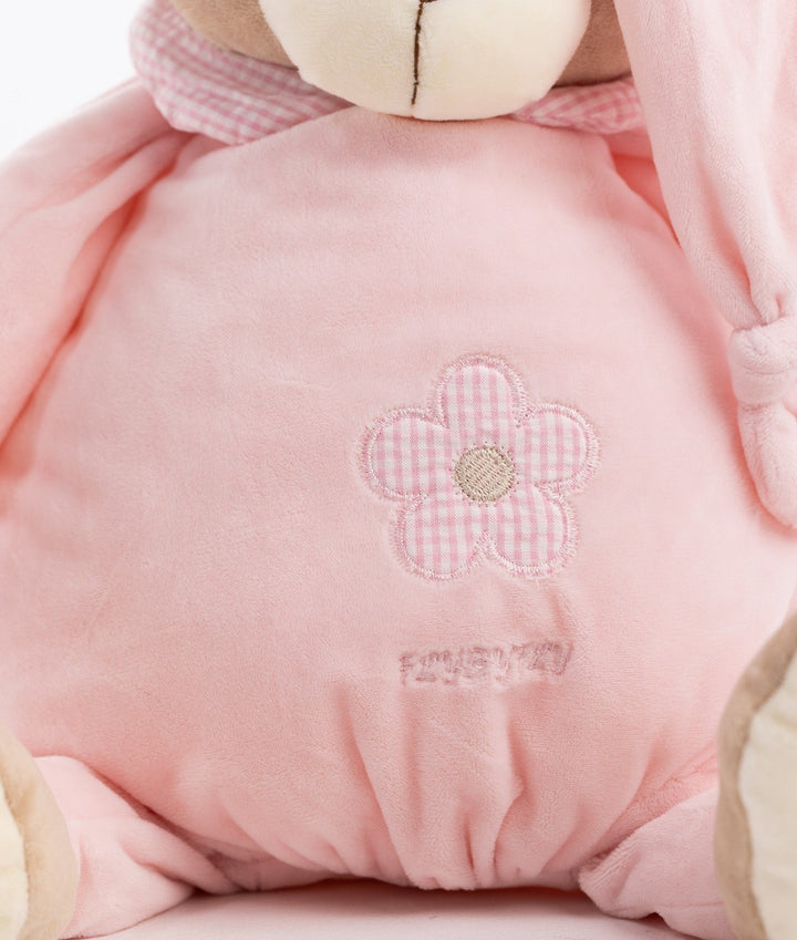Close-up of pink plush fabric texture and embroidered flower detail