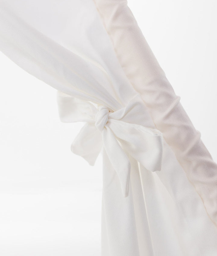 Close-up of white cotton teepee flap tied with neat bow knot