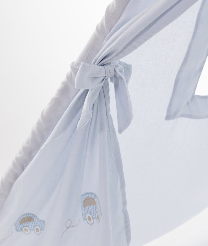 Close-up of light blue cotton teepee fabric knot closure and checkered car motifs