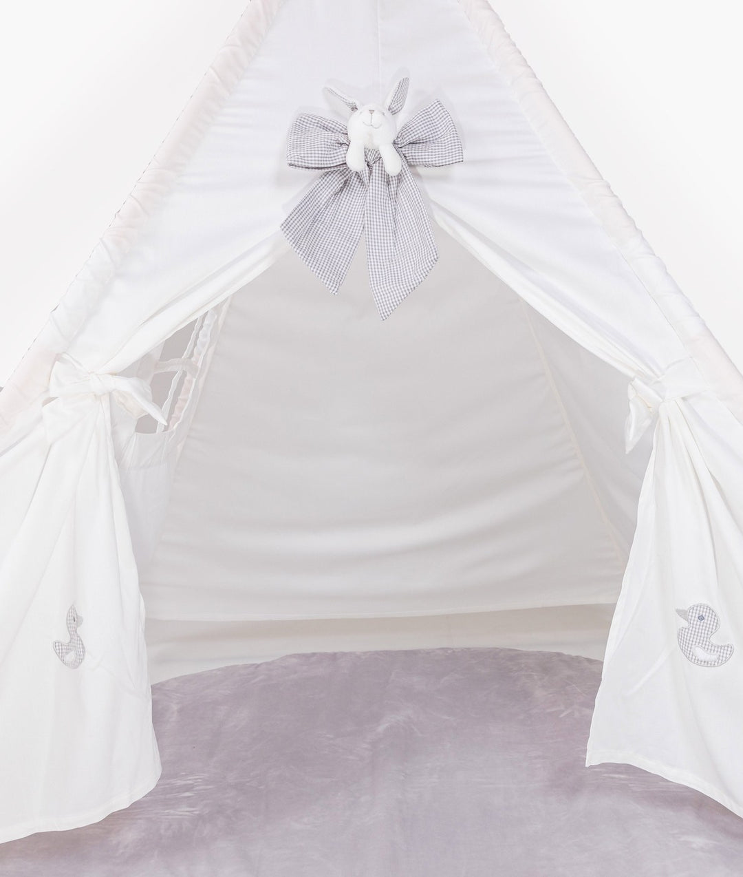 Front view of white teepee tent with grey gingham bunny appliqué and duck embroidery