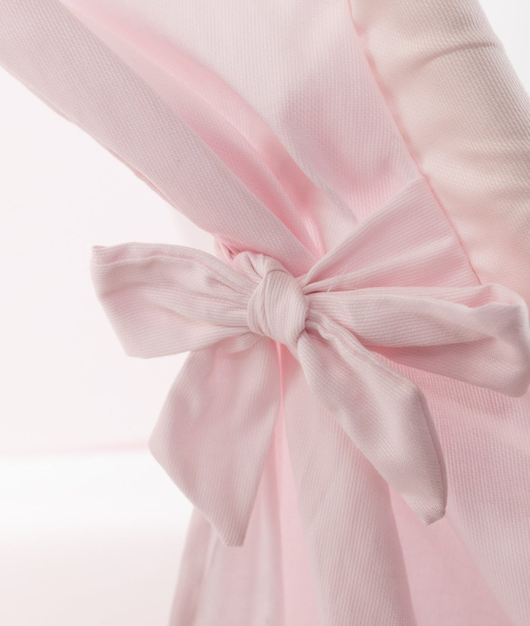 Close-up of pink ribbed cotton teepee fabric texture and stitching