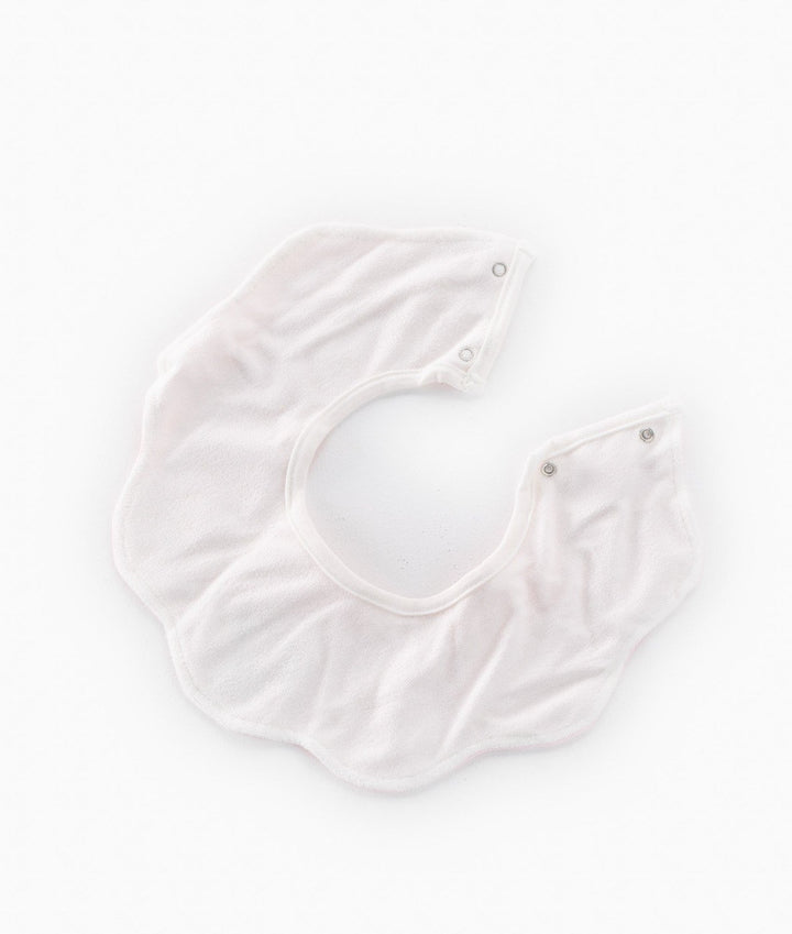 Back view of waterproof pink baby bib showing moisture-resistant lining and snap buttons
