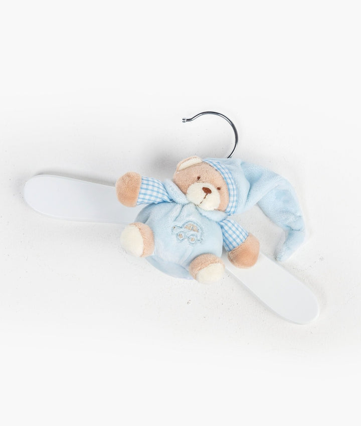 Top-down flat lay of blue teddy bear wooden hanger on white background