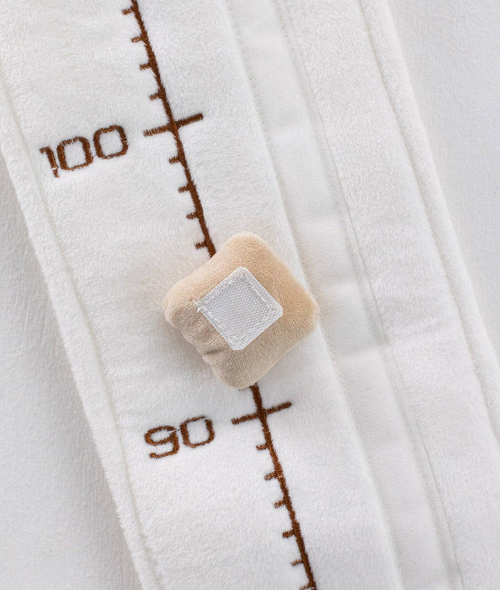White and beige baby growth chart