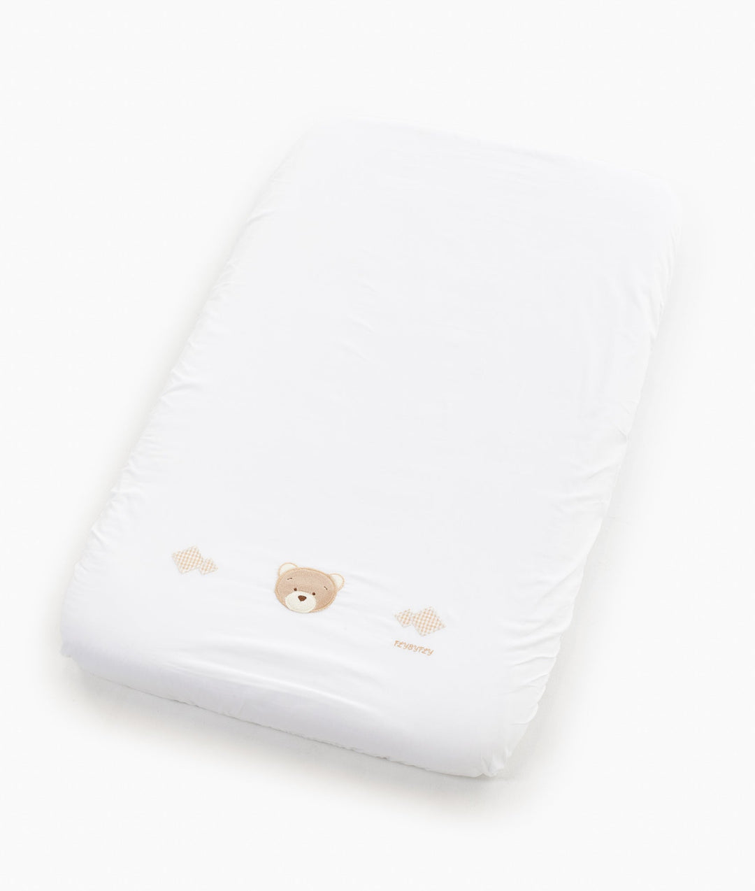 White and beige baby bassinet bedding